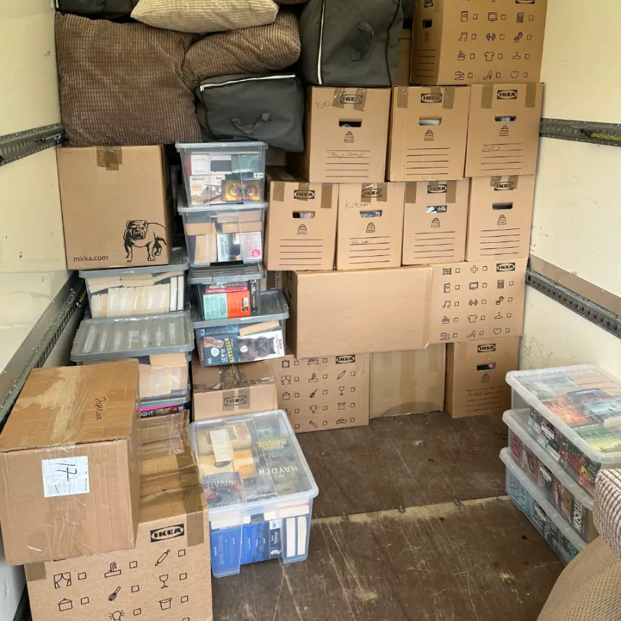 Packed boxes and crates stacked safely inside the removals van