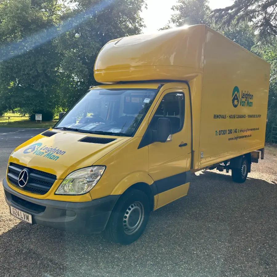 Front three-quarter view of the yellow Removals Leighton Buzzard Mercedes Sprinter Luton